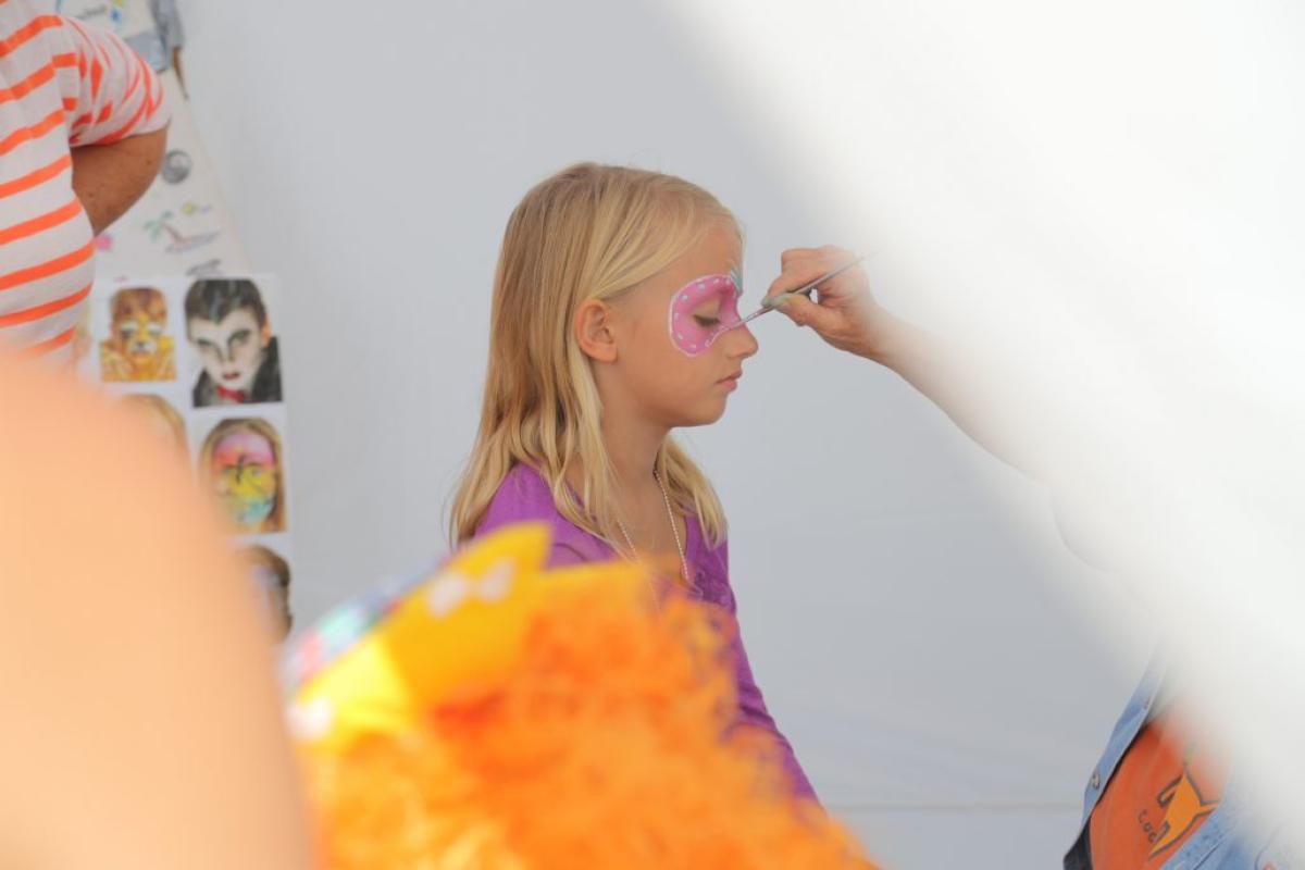 girl having her face painted